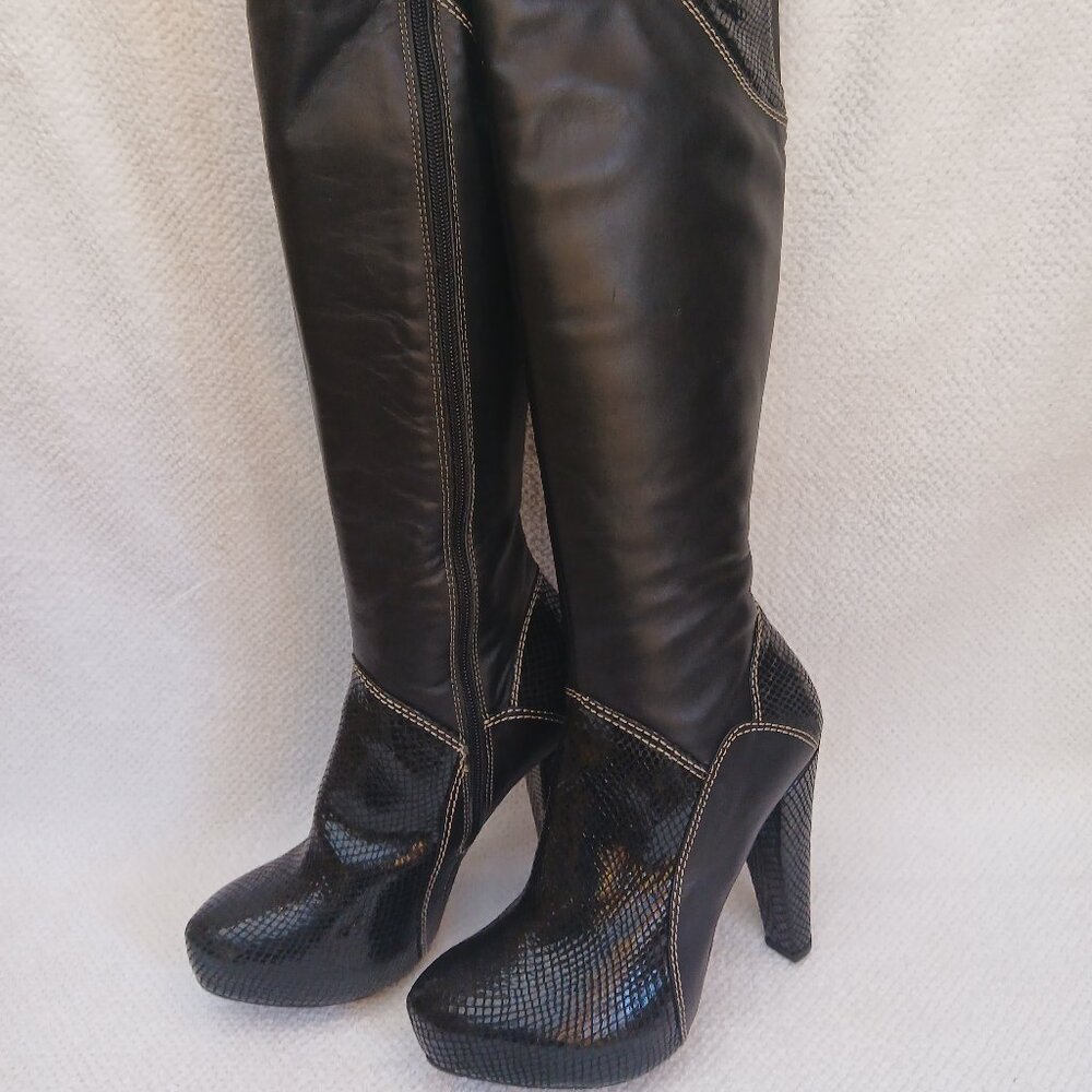 Black tall leather stiletto heel boots.